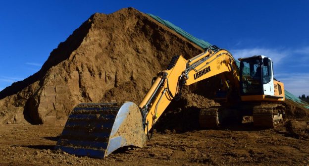 Excavator with dirt pile